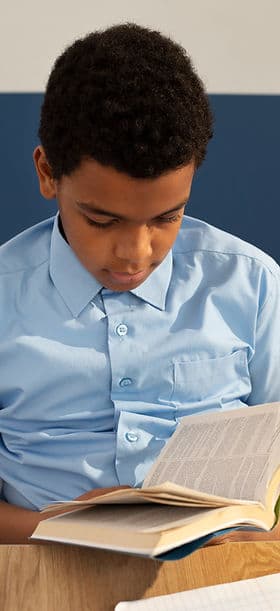 A student reading an open book