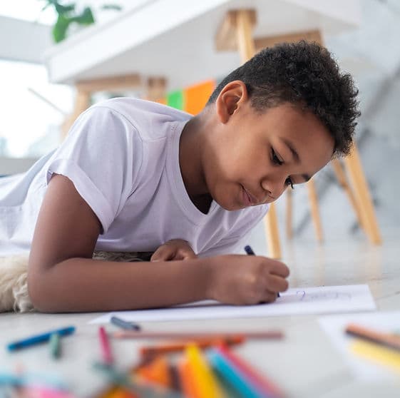 A child working with materials at a table