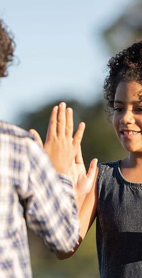 A student greeted with a high five on arrival