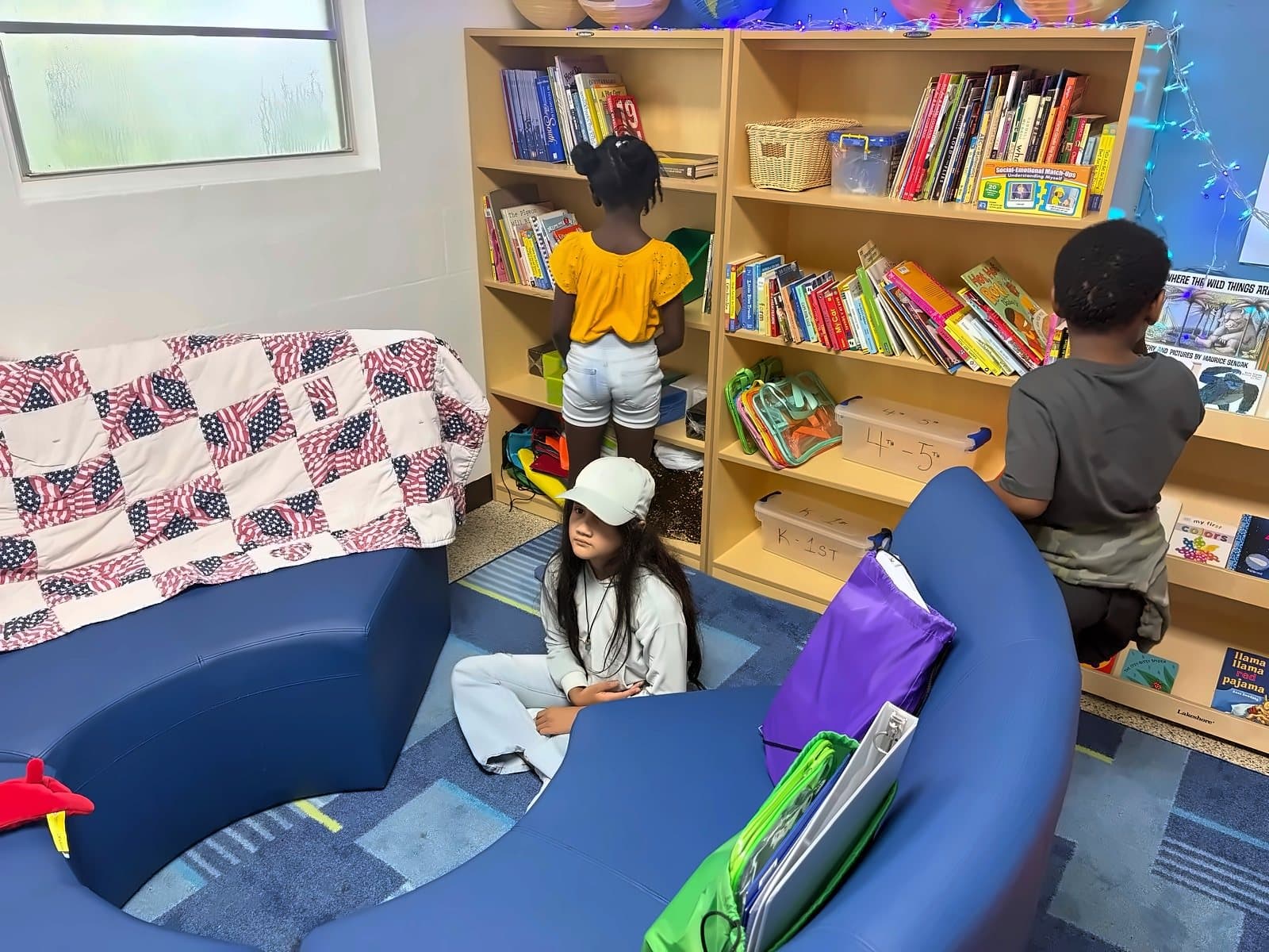 SWREA students choosing books in the classroom library