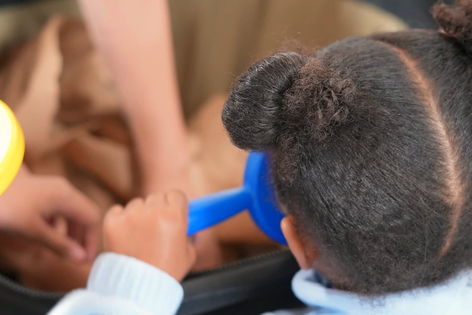 A SWREA student peering through a magnifying glass