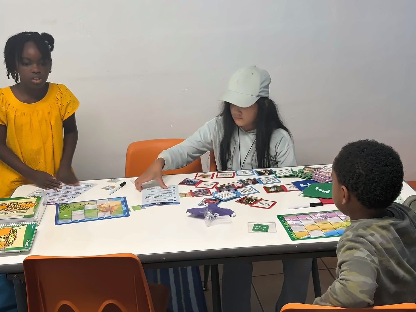 SWREA students playing a learning game together at a table