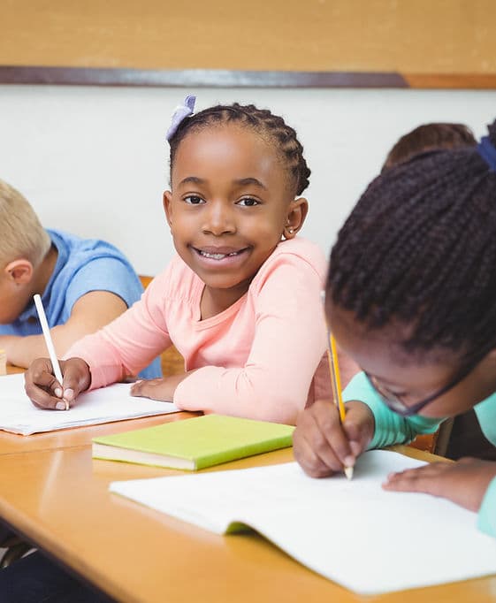 A student writing at her desk